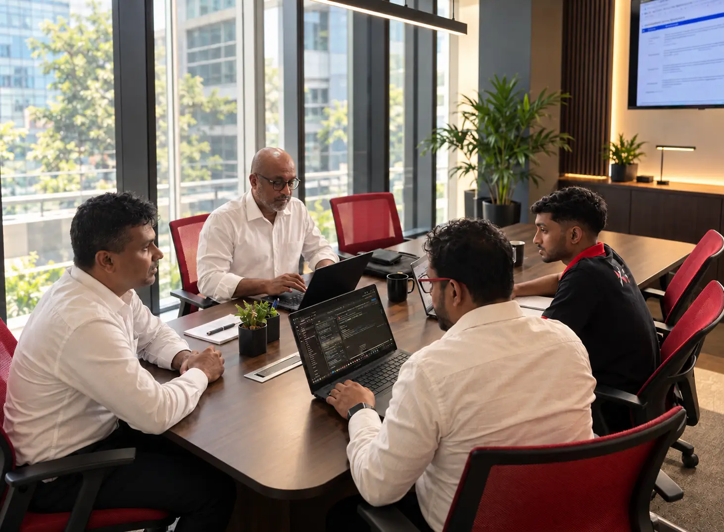 Team working with documents on dual monitors
